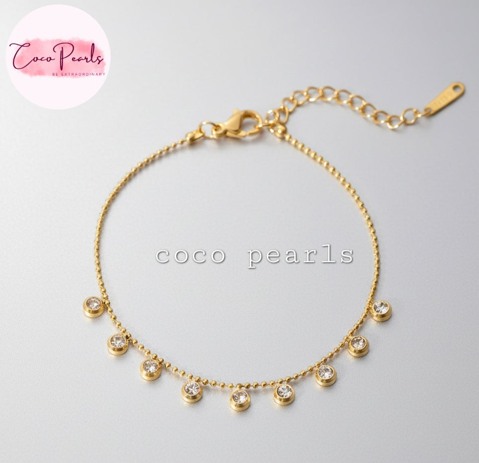 Coco Pearls Stainless steel anti tarnish Gold sparkling stars bracelet with small diamonds on ball chain displayed on a light gray background, 