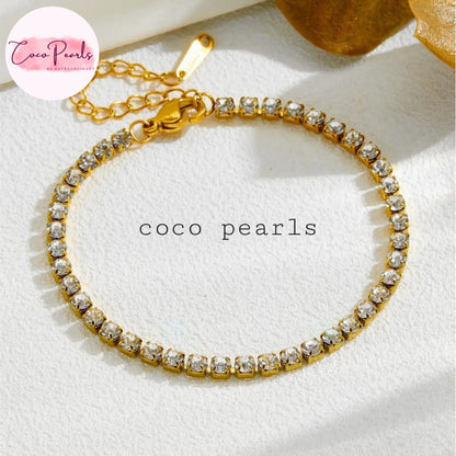 Coco Pearls Stainless Steel Anti Tarnish Gold sparkling delight bracelet with clear stones on a white surface