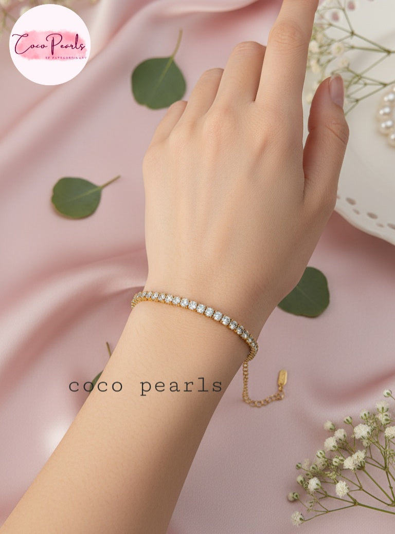 Coco Pearls Stainless Steel Anti Tarnish Gold sparkling delight bracelet worn on a pink fabric background.