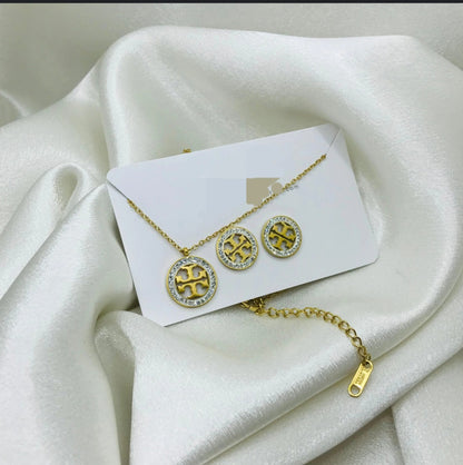 Coco Pearls Stainless Steel Anti Tarnish Gold infinity glow set with diamond studded necklace and earrings on a white fabric background