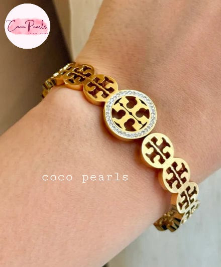 Coco pearls stainless Steel anti tarnish gold sparkly vibe handcuff displyed on hand
