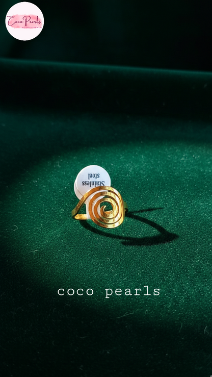 coco pearls stainless steel anti tarnish Gold spiral ring on a dark green fabric background 