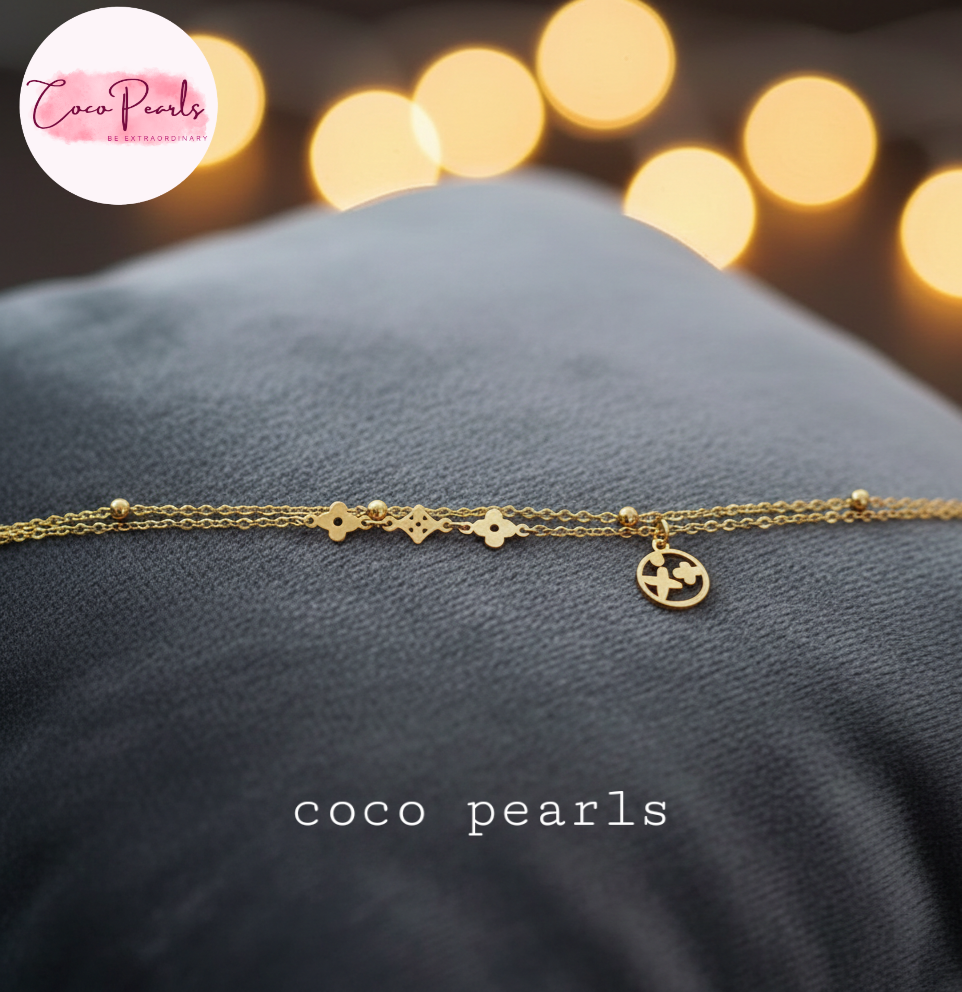 coco Pearls Stainless steel anti tarnish gold starlight bracelet wit dual chain and charm displayed on black cushion