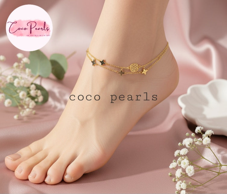 Coco Pearls Stainless steel Anti Tarnish Gold starry night anklet on a foot featuring flowers and a soft pink background.