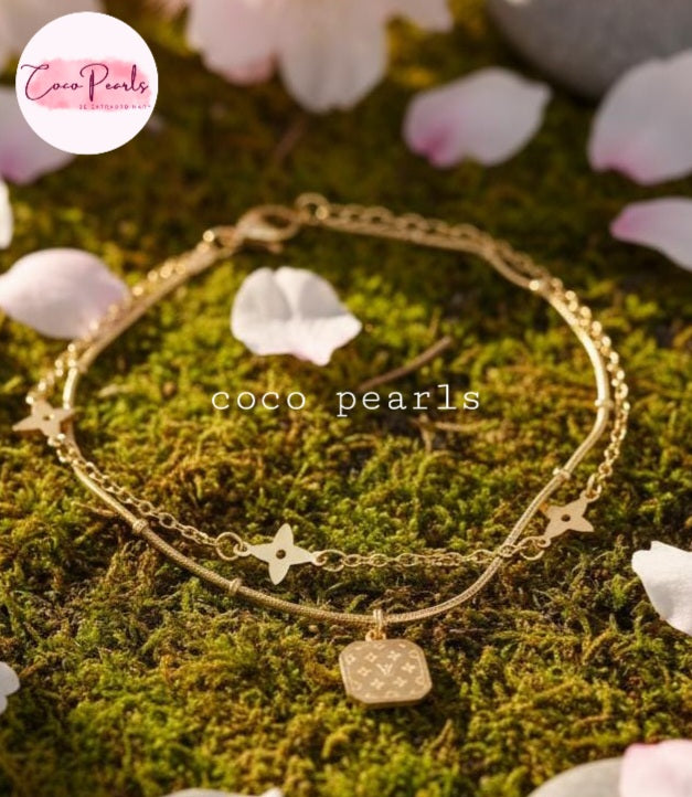Coco Pearls Stainless steel Anti Tarnish Gold starry night anklet with charms on a green moss background with cherry blossom petals