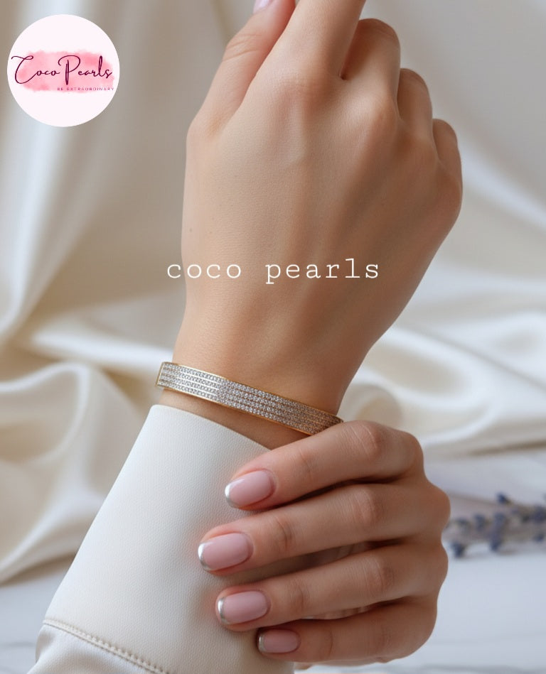 Coco Pearls Stainless Steel Anti tarnish gold stellar stack handcuff bangle bracelet with 4 lines of diamonds displayed on hand