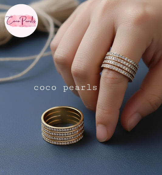 Coco Pearl stainless steel Anti tarnish  Gold stellar stack ring with 4 layer rhinestones on a blue surface