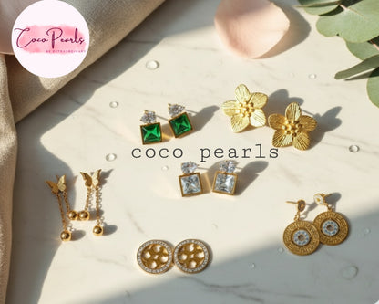 Coco Pearls Stainless Steel Anti Tarnish Collection of gold and green earrings on a marble surface 