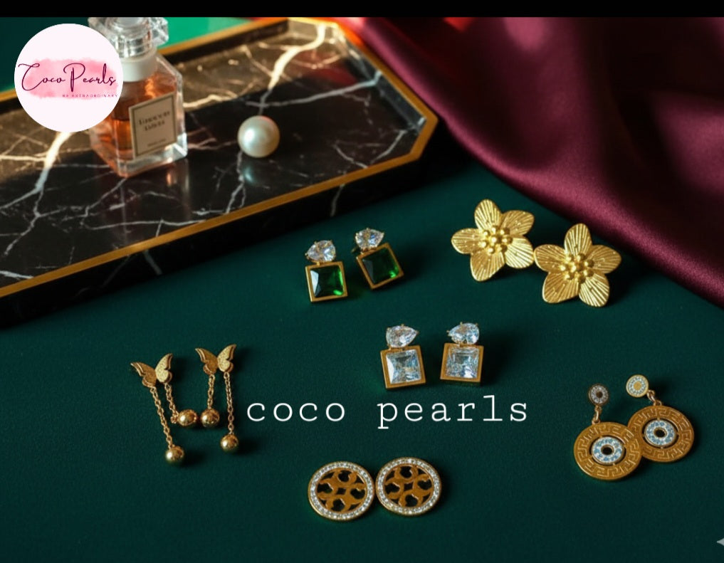 Coco Pearls Stainless Steel Anti Tarnish Collection of earrings on a dark green surface