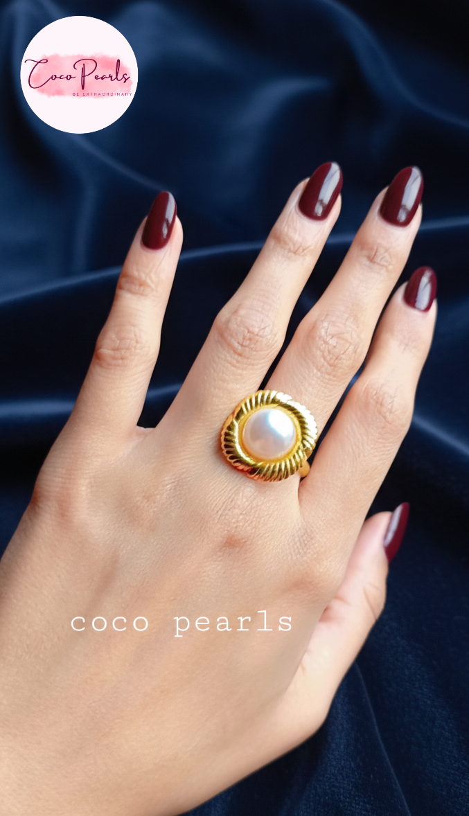 coco pearls stainless steel anti tarnish gold sun kissed pearl adjustable ring  with pearl in center of gold flower displayed on hand