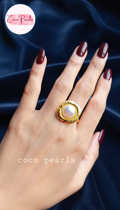 coco pearls stainless steel anti tarnish gold sun kissed pearl adjustable ring  with pearl in center of gold flower displayed on hand