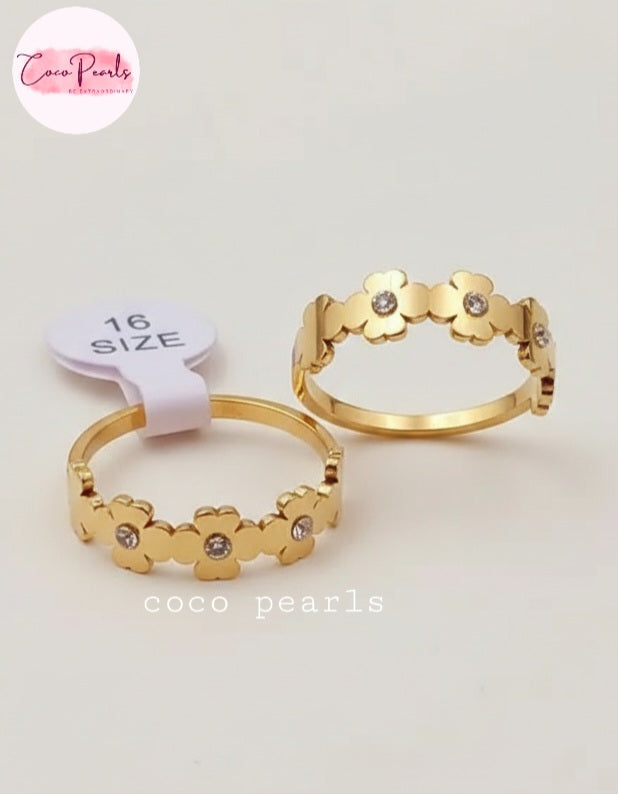 Coco Pearls Stainless Steel Anti tarnish Gold sunshine bloom floral rings on a light background