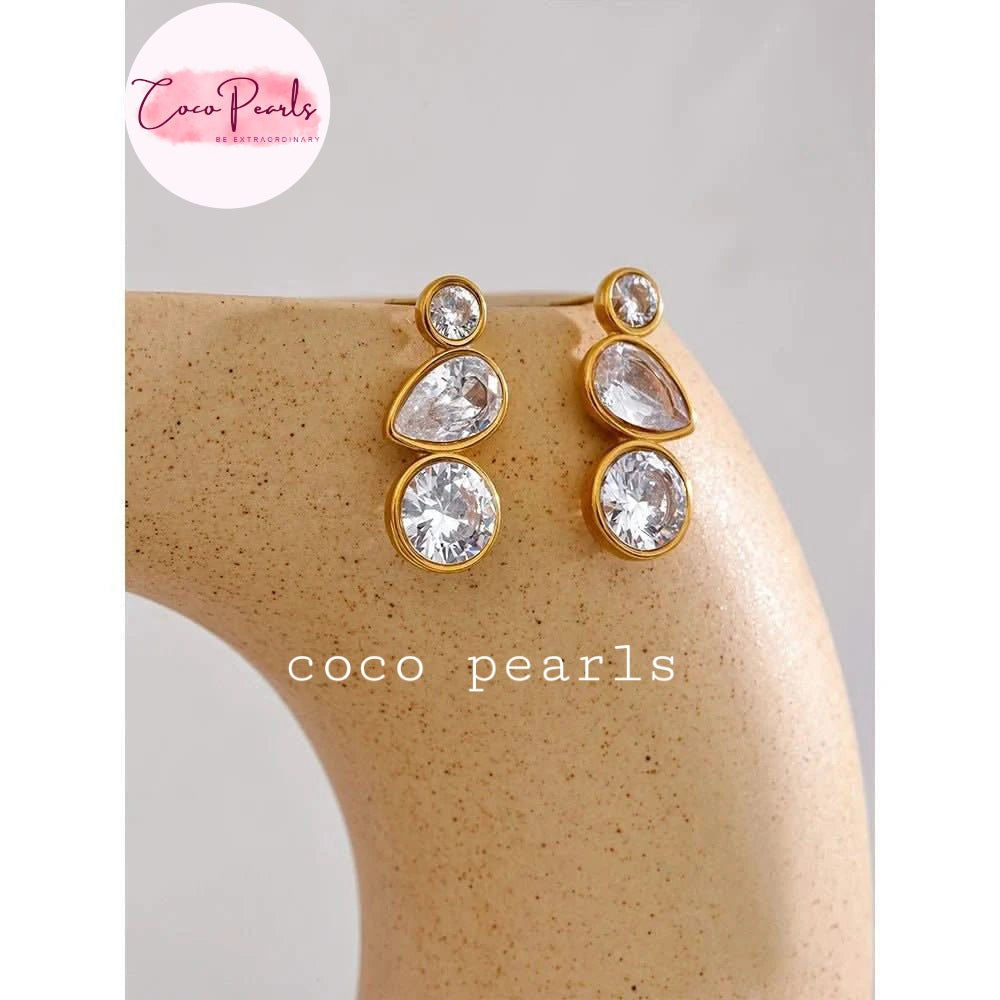 coco pearls stainless steel anti tarnish tri sparkle studs Gold and crystal earrings on a mannequin 
