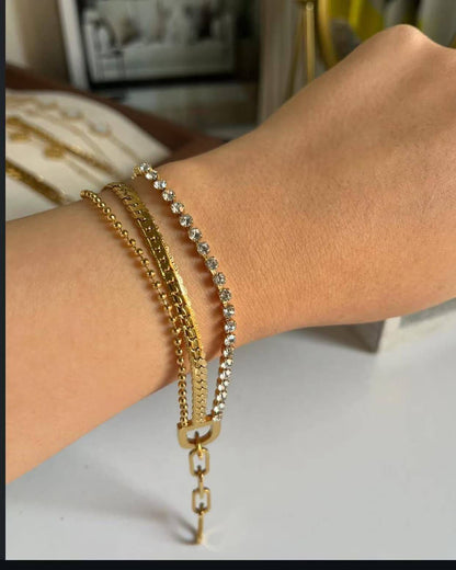 Coco Pearls Stainless steel anti tarnish Gold triple harmony bracelets with dot chain mesh chain and diamond chain on a wrist with a blurred indoor background