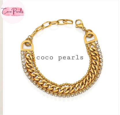 Coco Pearls Stainless Steel Anti Tarnish Gold triple threat glam bracelet with 3 layer stack bracelet. dot chain, thick chain and rhinestone chain displayed on white surface