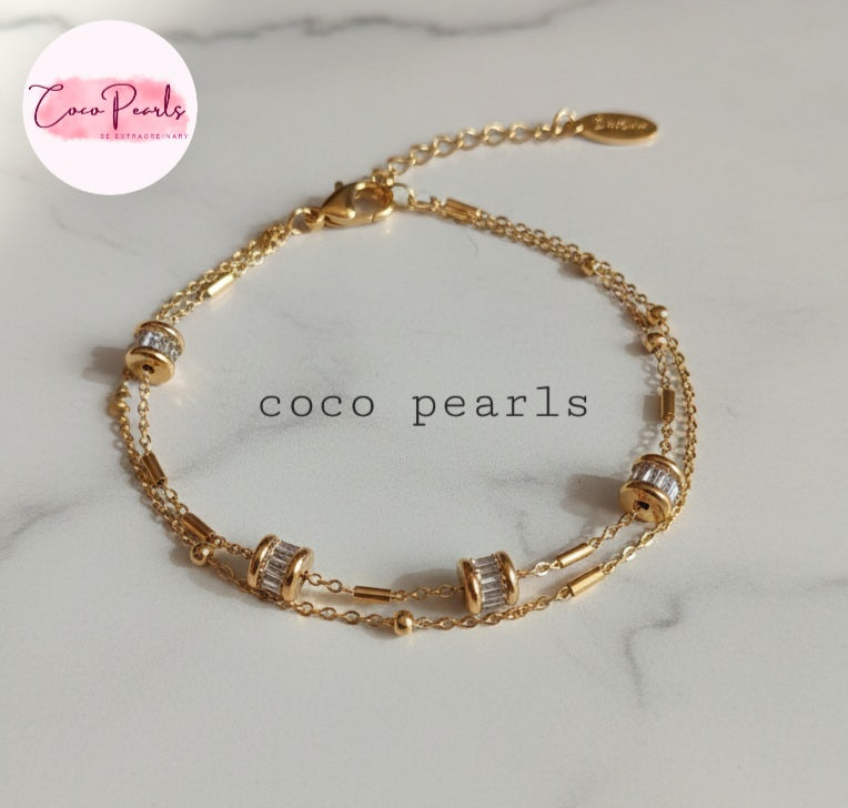 Coco Pearls Twinkle chain Stainless steel anti tarnish Gold bracelet with zircon on a marble background