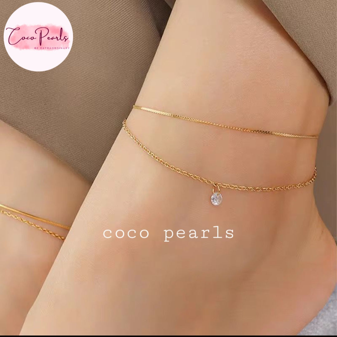Coco Pearls Stainless Steel Anti Tarnish Gold twinkle duo anklet with double chain anklet with diamond on a person's ankle