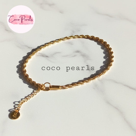 Coco Peals Stainless Steel anti  tarnish Gold rope chain bracelet with a small round charm on a light marble background