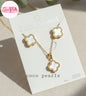 coco pearls stainless steel anti tarnish gold and white clover set with necklace and earrings displayed on a white card
