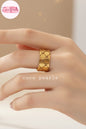 Tarnish Two gold woven rings with geometrical design on a hand